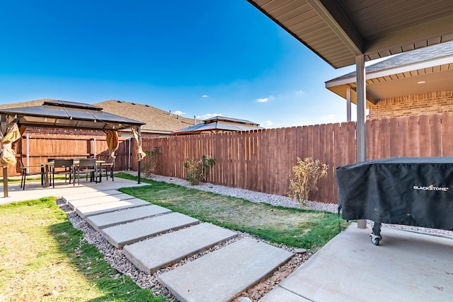 fenced backyard with a gazebo and a patio area