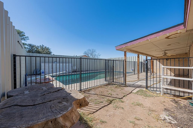 view of swimming pool featuring a fenced in pool, a fenced backyard, a patio, and ceiling fan