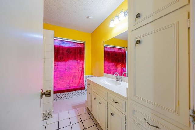 full bath featuring a shower with curtain, tile patterned flooring, a textured ceiling, and vanity