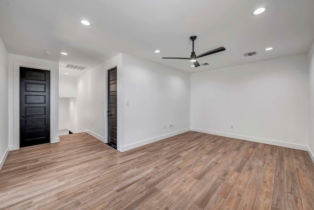 empty room with ceiling fan and light wood-type flooring