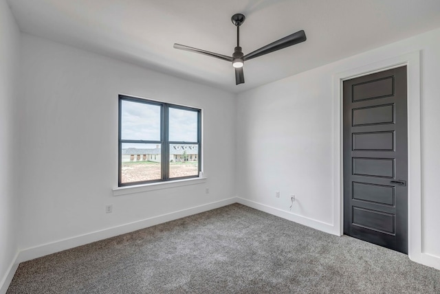 spare room featuring ceiling fan and carpet