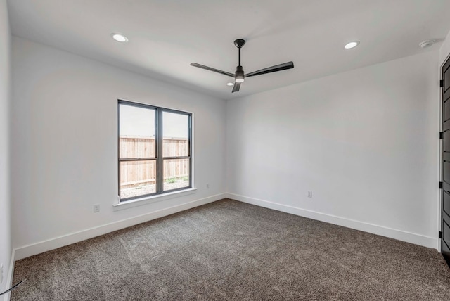 carpeted spare room with ceiling fan