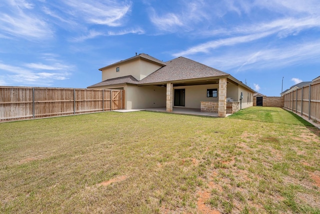 rear view of house with a yard and a patio area