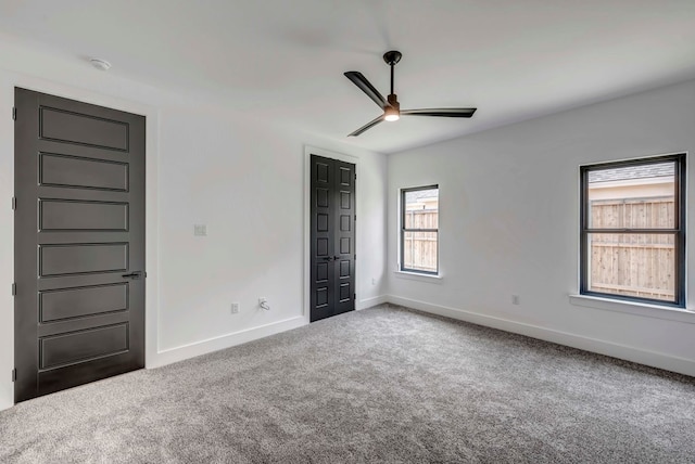 unfurnished bedroom featuring carpet floors, ceiling fan, and a closet