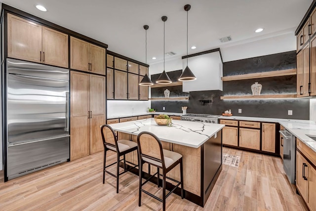 kitchen with custom exhaust hood, a center island, light hardwood / wood-style flooring, pendant lighting, and stainless steel appliances