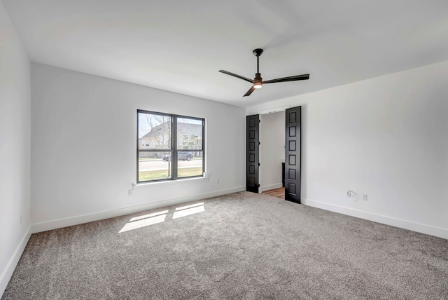 unfurnished bedroom with ceiling fan and carpet floors