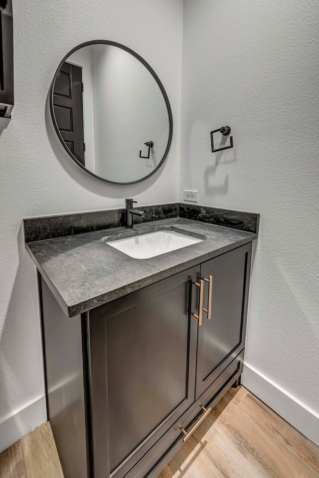 bathroom with vanity and hardwood / wood-style flooring