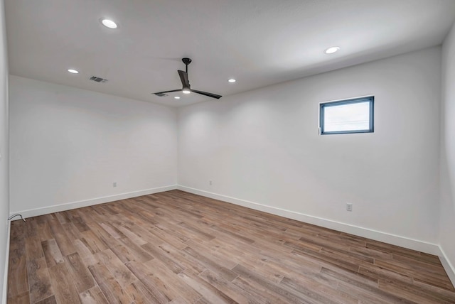 empty room with ceiling fan and light wood-type flooring