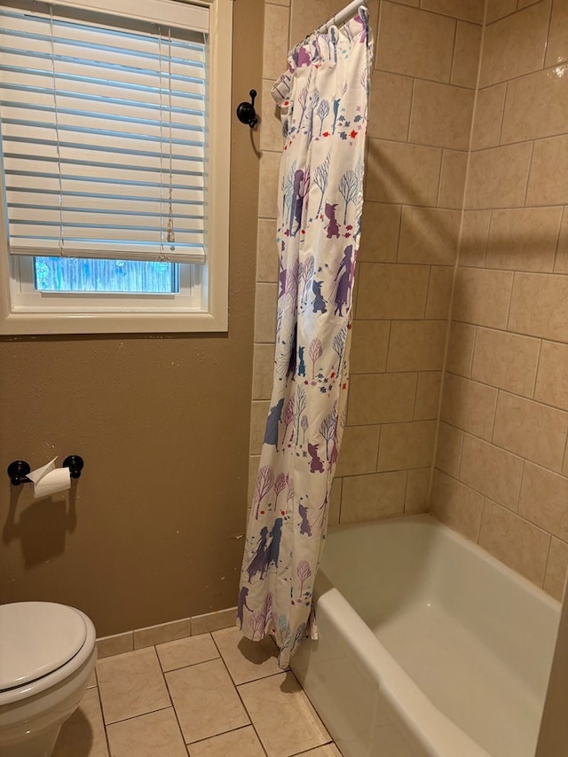 bathroom with tile patterned floors, shower / tub combo with curtain, and toilet