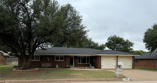 ranch-style home featuring a front yard and a garage