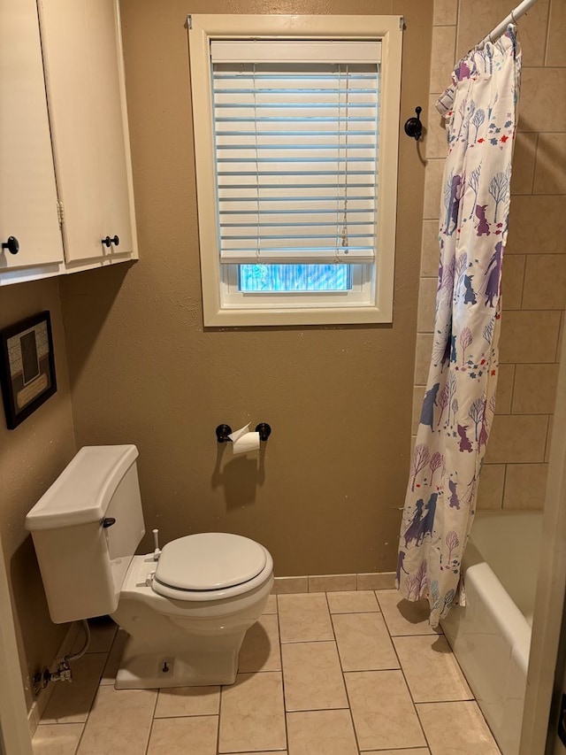 bathroom with tile patterned floors, shower / tub combo, and toilet