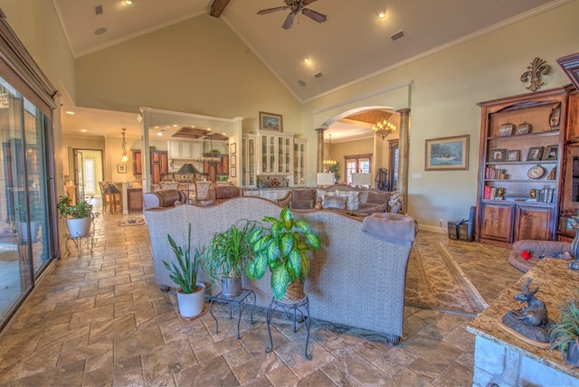 living room featuring crown molding, ceiling fan, high vaulted ceiling, and ornate columns