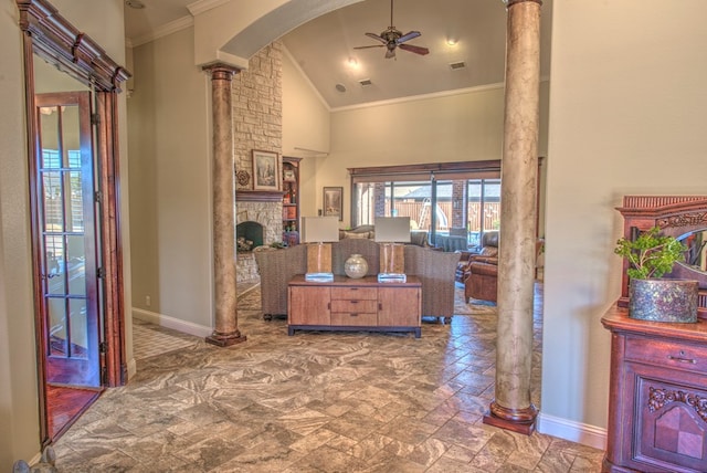 hallway with high vaulted ceiling, crown molding, and decorative columns