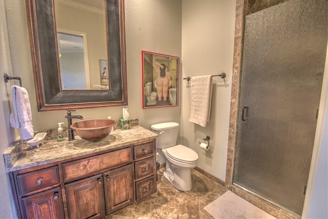 bathroom with vanity, ornamental molding, an enclosed shower, and toilet