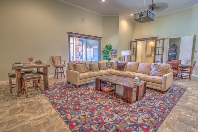 living room with crown molding and a towering ceiling