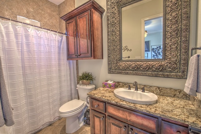 bathroom featuring vanity, tile patterned floors, and toilet