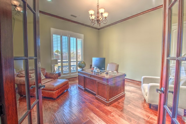 office area with hardwood / wood-style floors, a notable chandelier, ornamental molding, and french doors