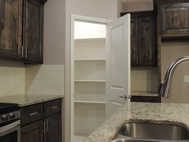 kitchen featuring decorative backsplash and dark brown cabinets