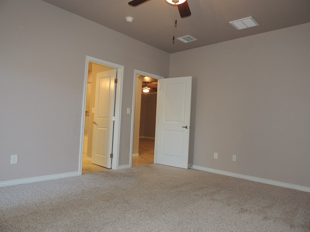 empty room featuring light carpet and ceiling fan