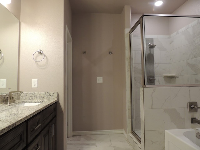 bathroom featuring vanity and independent shower and bath