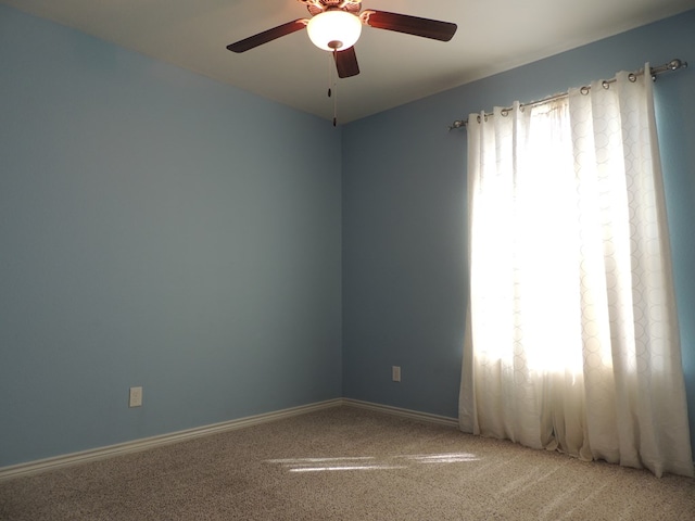 empty room with carpet flooring and ceiling fan