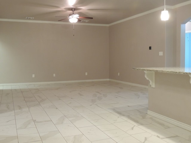 spare room with crown molding and ceiling fan