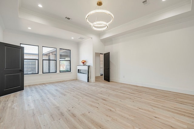 interior space with crown molding, an inviting chandelier, and light hardwood / wood-style flooring