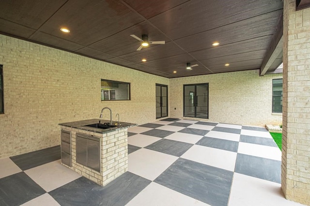 view of patio featuring ceiling fan and sink