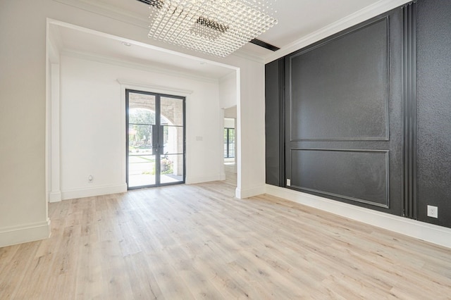 empty room featuring crown molding and light wood-type flooring