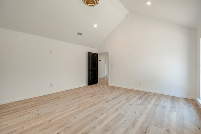 unfurnished room with high vaulted ceiling and light wood-type flooring