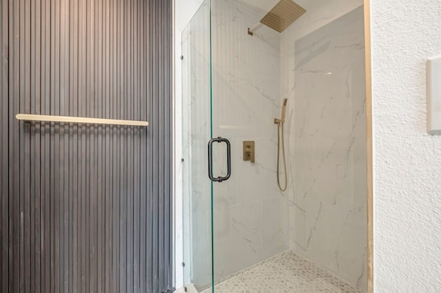 bathroom with a shower with door