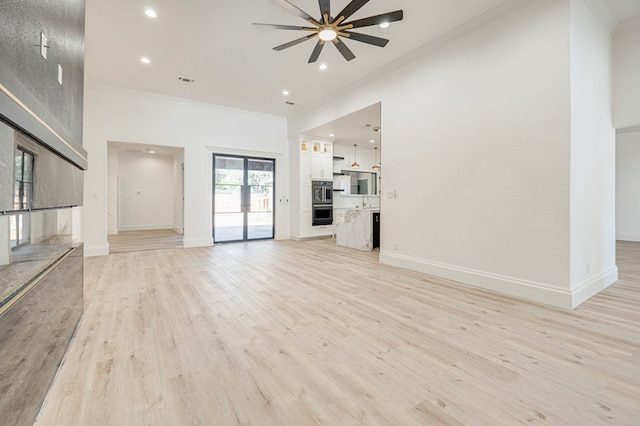 unfurnished living room with french doors, ceiling fan, ornamental molding, and light wood-type flooring