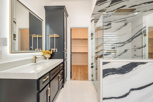 bathroom featuring vanity and a shower with shower door