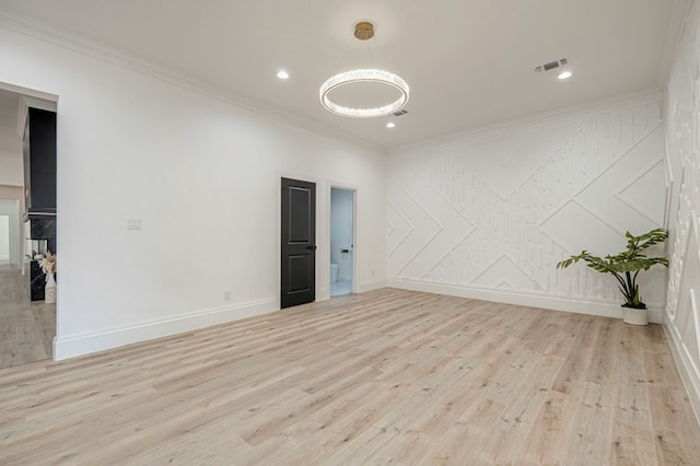 unfurnished room featuring crown molding and light wood-type flooring