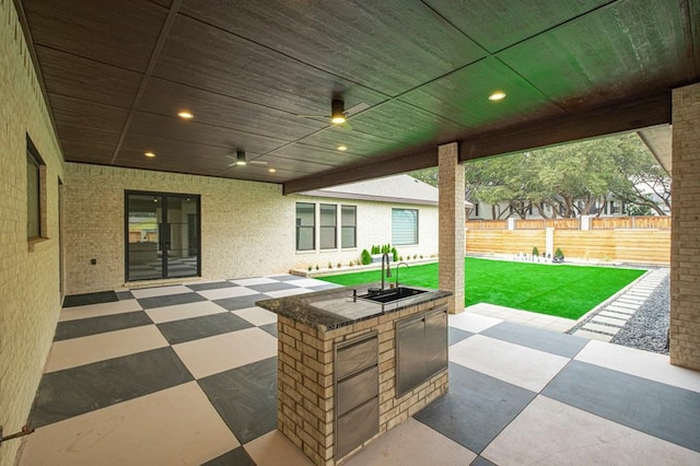 view of patio featuring an outdoor kitchen and sink