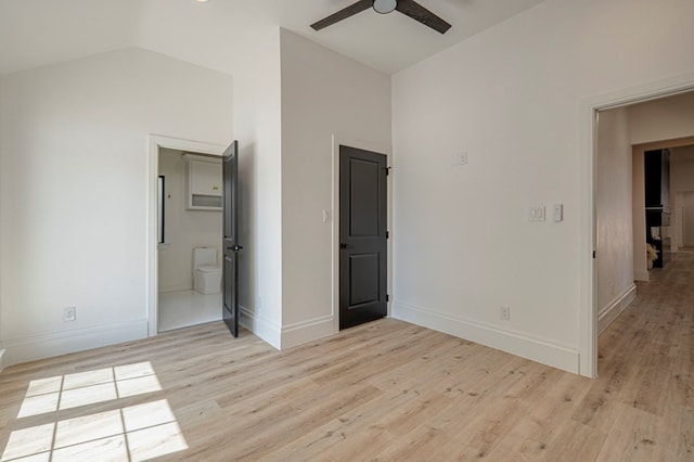 unfurnished bedroom with high vaulted ceiling, ensuite bath, light hardwood / wood-style floors, and ceiling fan