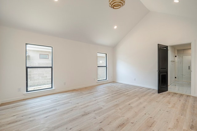 unfurnished room with light hardwood / wood-style flooring and high vaulted ceiling