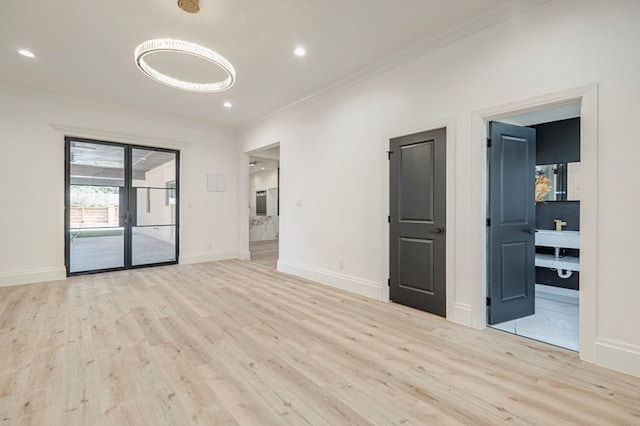 unfurnished room featuring ornamental molding and light hardwood / wood-style floors