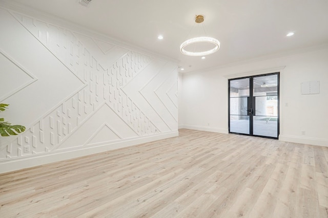 unfurnished room with ornamental molding, light hardwood / wood-style flooring, and french doors