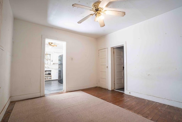 206 Austin, Big Spring, TX 79720 - unfurnished bedroom featuring fridge, hardwood / wood-style floors, and a ceiling fan