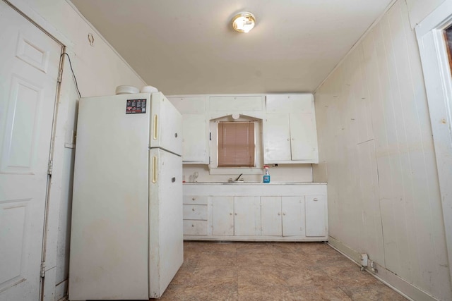 206 Austin, Big Spring, TX 79720 - kitchen featuring freestanding refrigerator, white cabinets, and light countertops