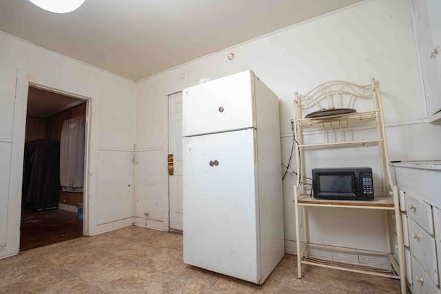 206 Austin, Big Spring, TX 79720 - kitchen featuring freestanding refrigerator, black microwave, and an office area