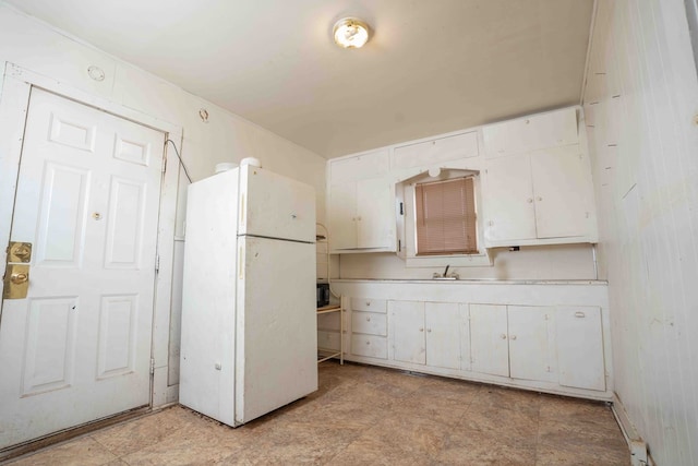 206 Austin, Big Spring, TX 79720 - kitchen featuring freestanding refrigerator, white cabinetry, and light countertops