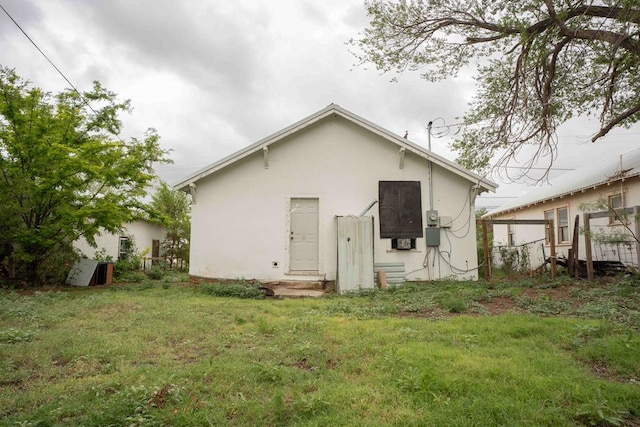 206 Austin, Big Spring, TX 79720 - back of property featuring stucco siding and a yard