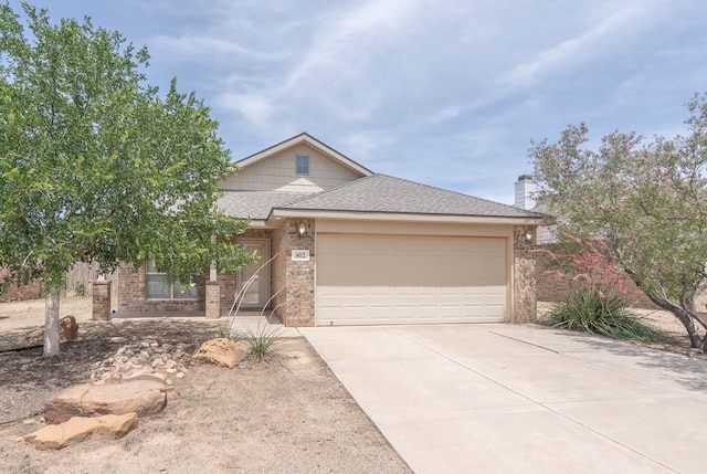 802 Wagner, Midland, TX 79707 - view of front facade featuring driveway, an attached garage, roof with shingles, brick siding, and a chimney