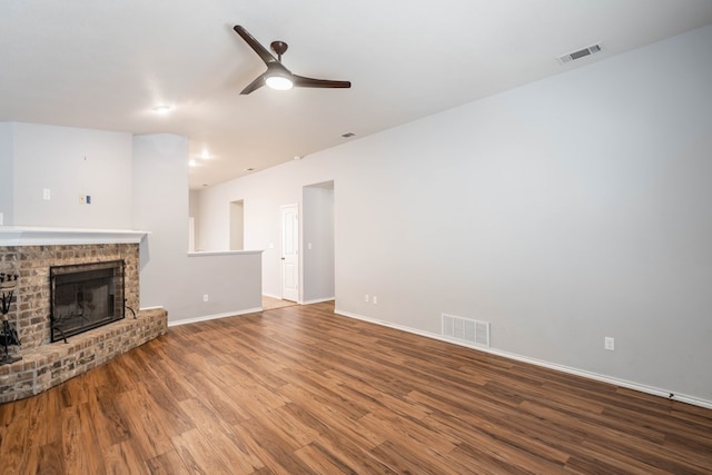 802 Wagner, Midland, TX 79707 - unfurnished living room with ceiling fan, wood finished floors, baseboards, and a brick fireplace