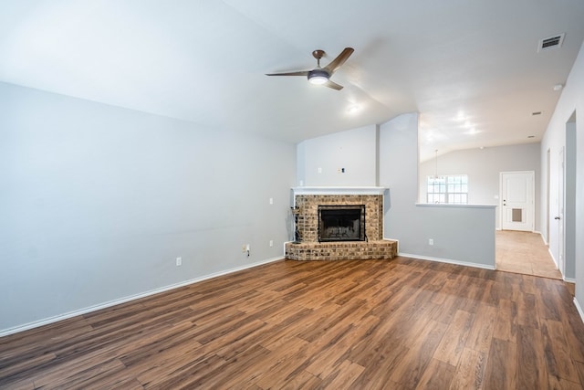 802 Wagner, Midland, TX 79707 - unfurnished living room featuring vaulted ceiling, ceiling fan, wood finished floors, baseboards, and a fireplace