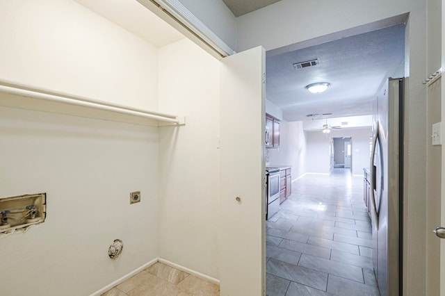 washroom with laundry area, visible vents, baseboards, ceiling fan, and hookup for an electric dryer