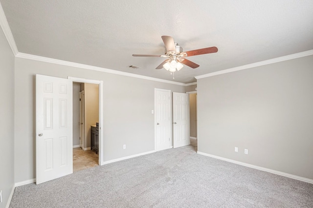 unfurnished bedroom with ornamental molding, light colored carpet, visible vents, and baseboards