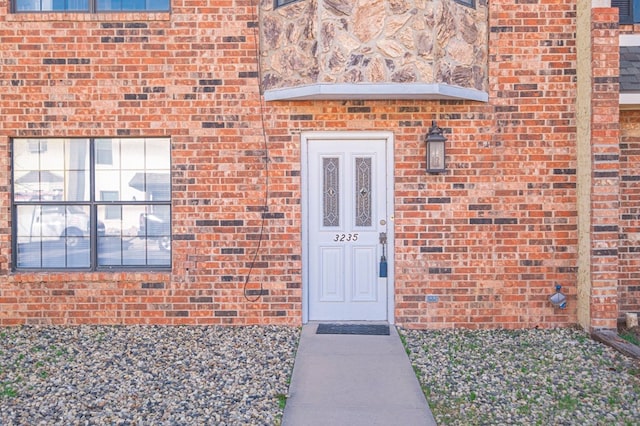 entrance to property with brick siding